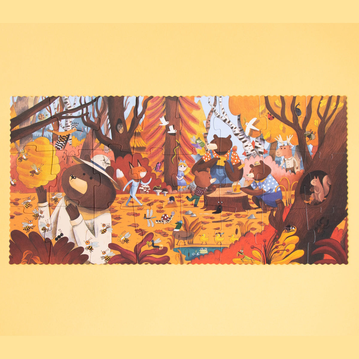 Whimsical Londji forest puzzle featuring bear family, bees, and woodland animals in a warm, autumn-colored illustration.