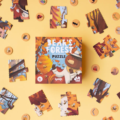 Londji Bear's Forest 24-piece nature observation puzzle box and colorful jigsaw pieces on a yellow background.