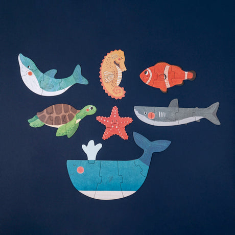 Londji wooden sea animal puzzles including a whale, shark, turtle, and starfish on a dark blue background.
