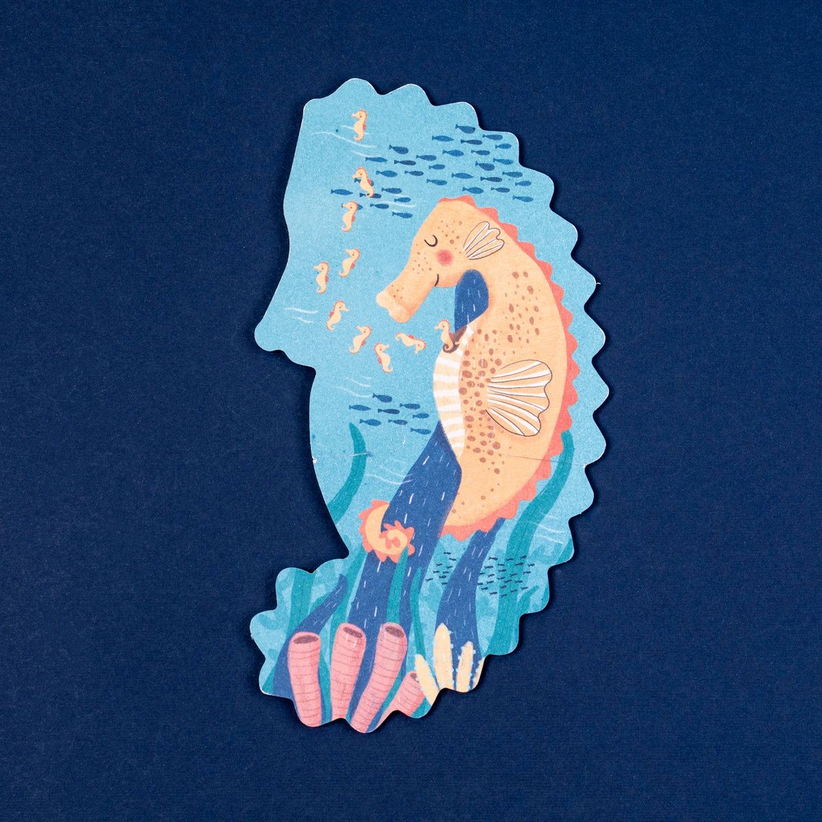 Londji seahorse shaped puzzle piece featuring a colorful illustration of a seahorse family and underwater reef.