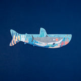 Londji shark-shaped puzzle for kids with detailed underwater coral reef illustration on a navy blue background.