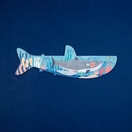 Londji shark-shaped puzzle for kids with detailed underwater coral reef illustration on a navy blue background.