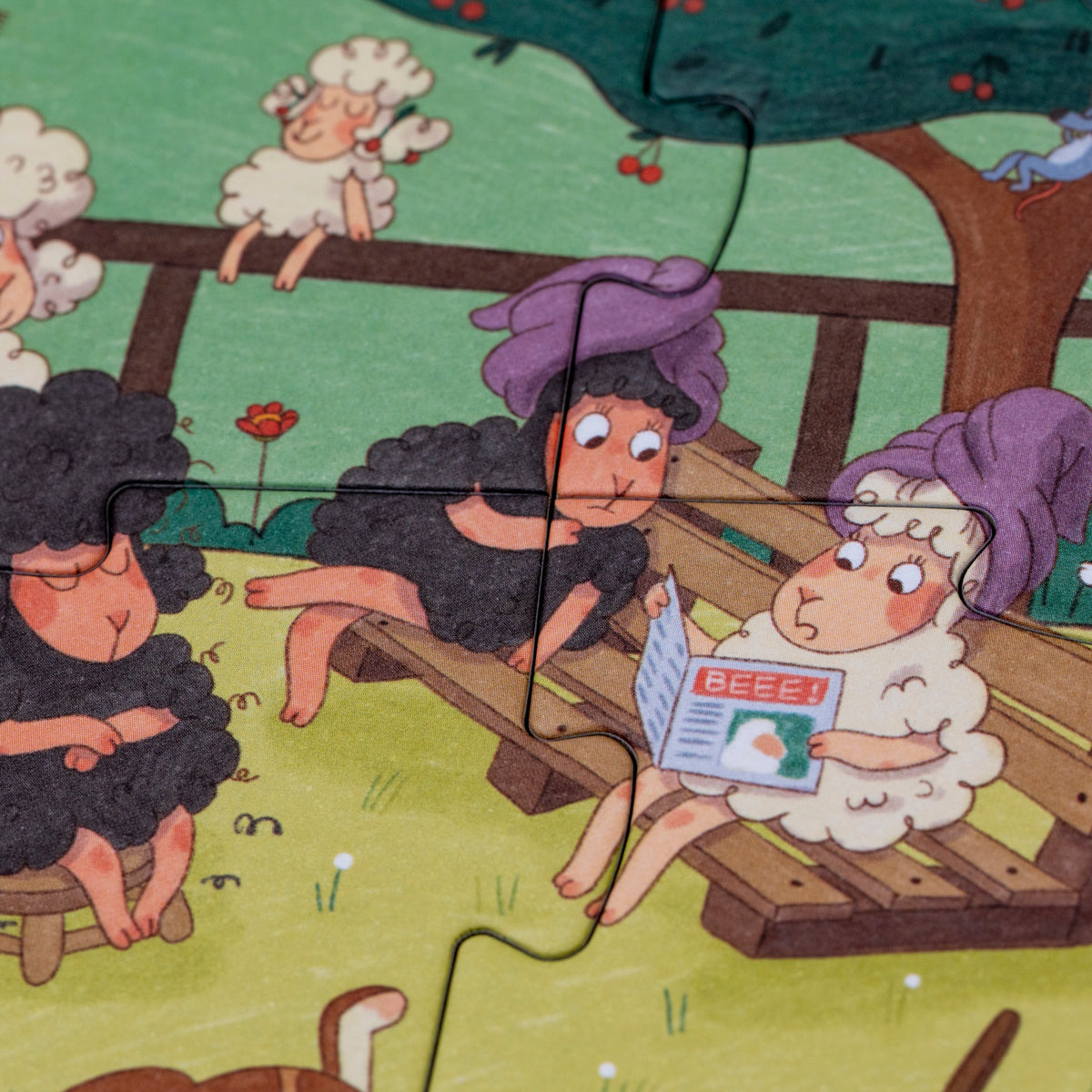 Close-up of Londji Farmtastic puzzle pieces showing funny sheep with purple towels reading a "BEEE!" newspaper.