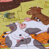 Londji Farmtastic jigsaw puzzle featuring a whimsical illustration of sleeping cows and a turtle on a farm.