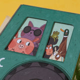 Close-up of a Londji Farmtastic puzzle box featuring a purple cat in sunglasses, a pig, frog, duck, and sheep.