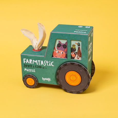 Londji Farmtastic Look & Find 36-piece puzzle in a green tractor-shaped box with fabric rabbit ears on a yellow background.