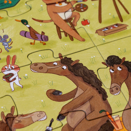 Close-up of Londji Farmtastic puzzle pieces showing illustrated horses, a rabbit, and a duck on a green field.