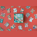 Rabbit's Garden nature observation puzzle box surrounded by colorful illustrated pieces on a solid terracotta background.