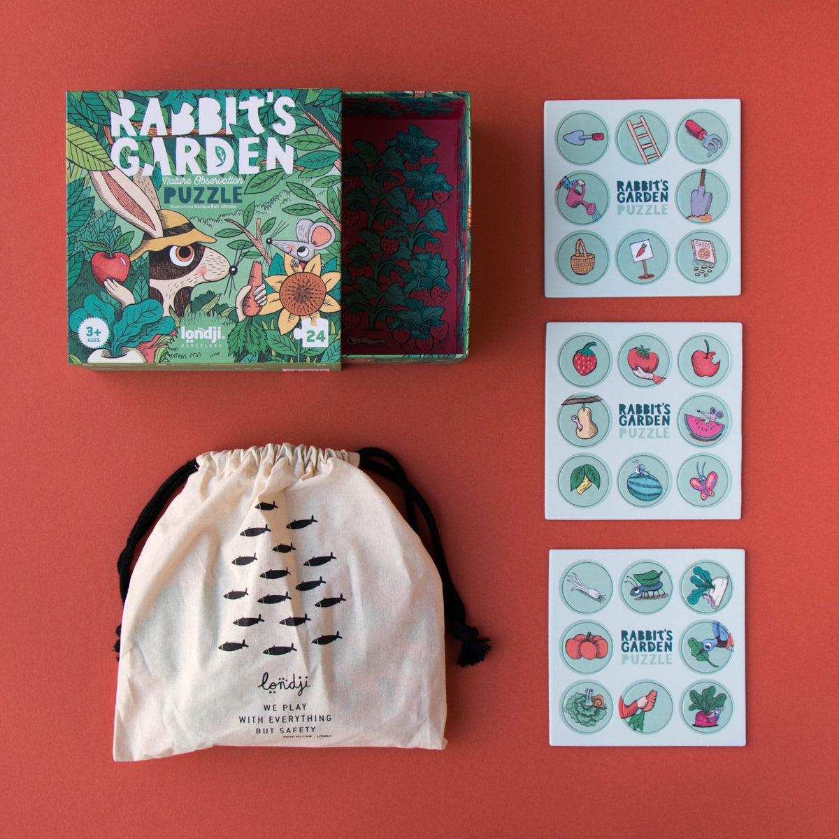 Londji Rabbit's Garden puzzle box with a canvas storage bag and three matching tiles featuring garden-themed illustrations.
