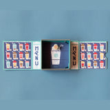 Londji Shakes tiny board game with colorful milkshake menu cards, a wooden die, and a blue illustrated box.