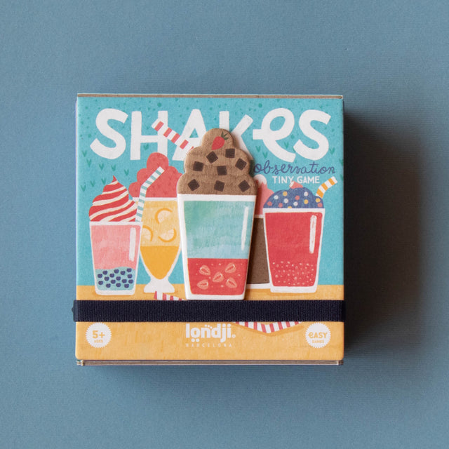 Londji Shakes Tiny Game observation card game box for ages 5 plus, featuring colorful milkshake illustrations.