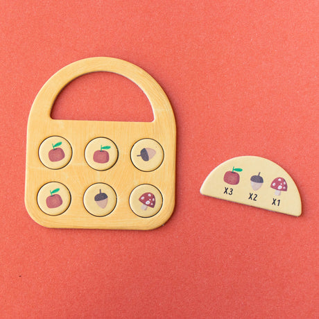 Londji Strawberries Tiny Game featuring a wooden basket board, scoring tokens, and forest-themed game pieces.