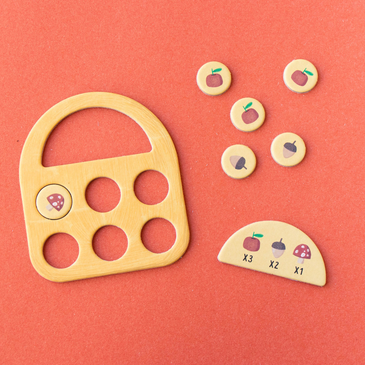 Londji Strawberries Tiny Game featuring a wooden basket board, scoring tokens, and forest-themed game pieces.