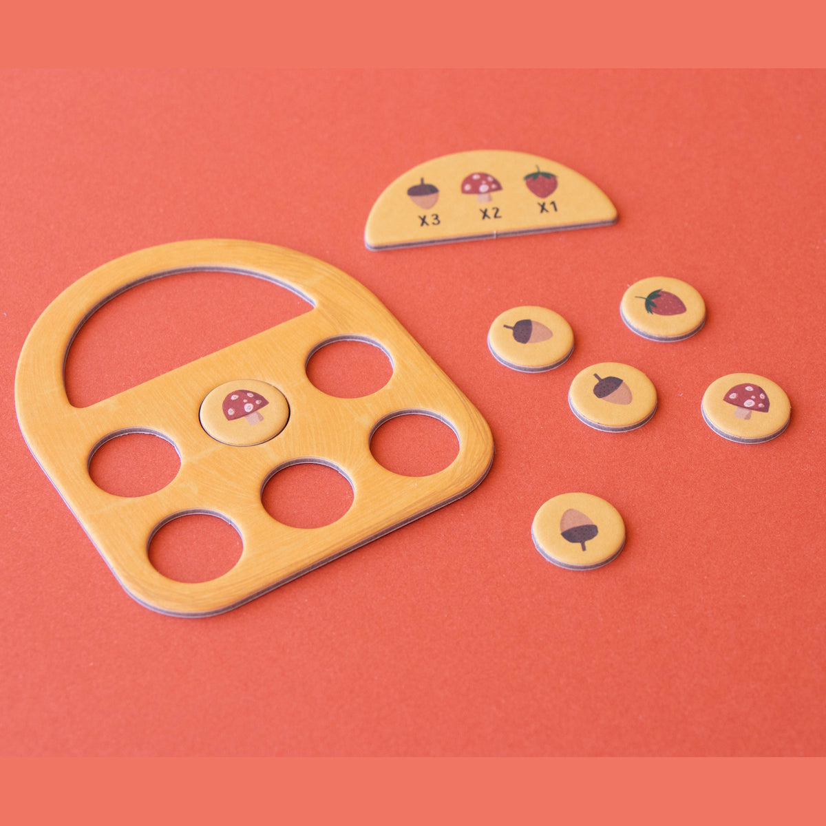 Londji Tiny Game Strawberries featuring a wooden basket board, scoring tokens, and forest-themed game pieces.