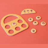 Londji Tiny Game Strawberries featuring a wooden basket board, scoring tokens, and forest-themed game pieces.