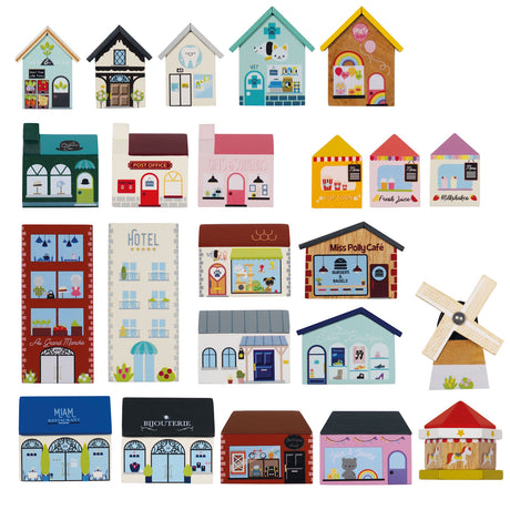 Collection of wooden buildings and city structures from a toy train set, including shops, a hotel, café, and windmill.