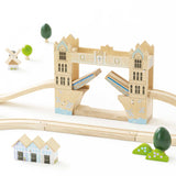 Wooden Tower Bridge toy with drawbridge open, wooden tracks, small houses, and mini trees.