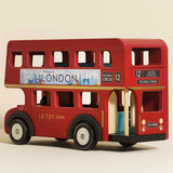 Red double-decker wooden London toy bus with route details and city skyline banner.