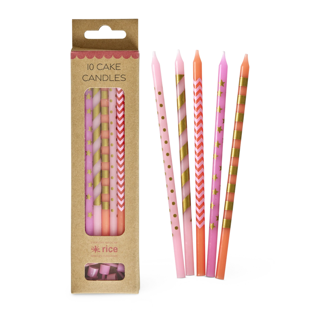 Set of 10 colorful cake candles with stripes, stars, and zigzag patterns in pink, orange, and gold hues. They are displayed against a white background.