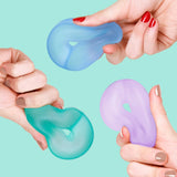 Three hands squeezing squishy, cool-toned ring-shaped memory gel stress toys.