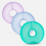 Three colorful ring-shaped memory gel stress loops in purple, light blue, and teal.