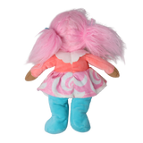 Back view of a plush doll with pink pigtails and a pastel dress against a white background.