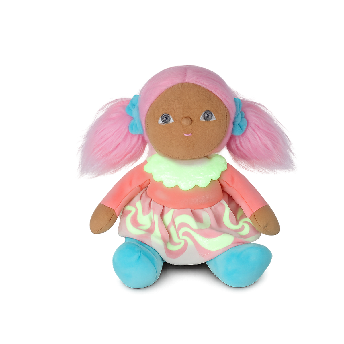 Plush doll with pink pigtails, a pastel dress, and blue shoes sitting against a white background.