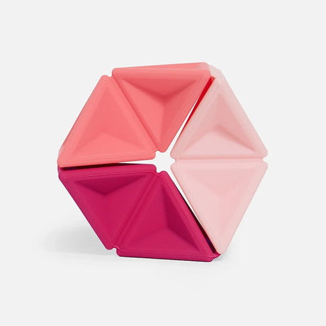 Hexagonal silicone fidget toy featuring triangular segments in three shades of pink.