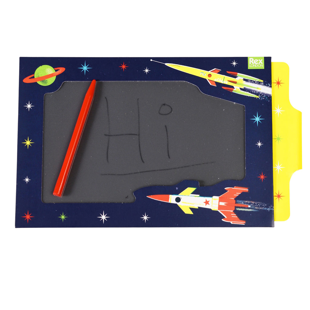 A colorful space-themed drawing board with a red pen, featuring rockets and stars on the border.