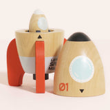 Wooden space rocket top placed beside the base, showing a smaller rocket inside the lower section.