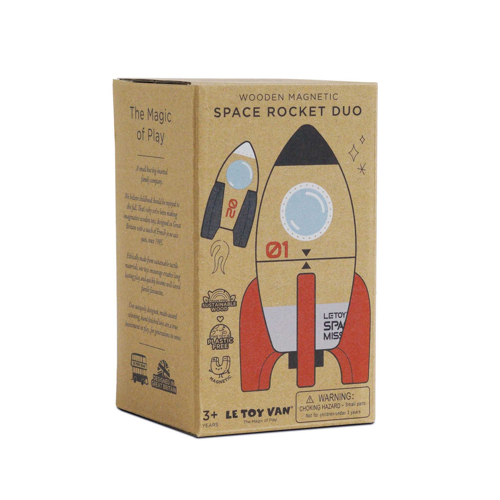 Cardboard packaging of a wooden magnetic space rocket toy for ages 3+, featuring illustrations of rockets and text about sustainable materials.