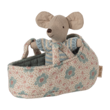 A tiny mouse in a soft blue striped knit outfit, tucked inside a floral fabric carry cot with handles—perfect for nurturing pretend play and adding charm to any Maileg collection.