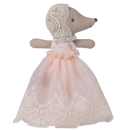 A plush hedgehog toy is dressed in a delicate, pink lace dress with a matching lace bonnet. The background is solid white, emphasizing the toy's elegance.