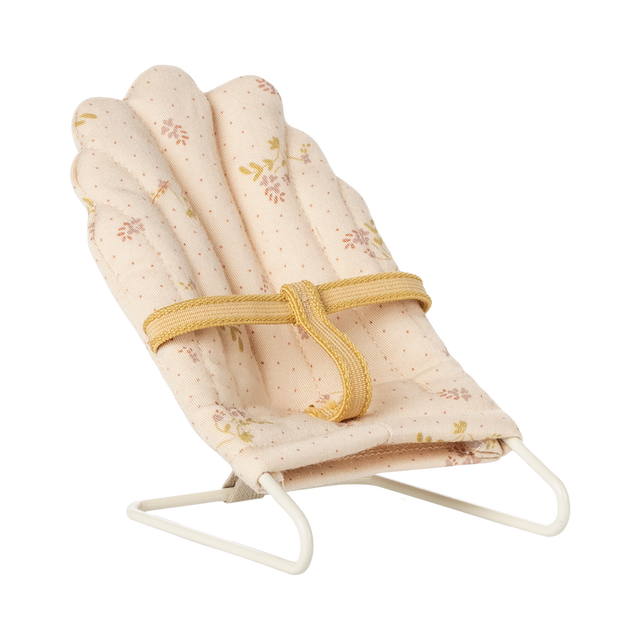 Soft, pink miniature doll chair with floral patterns on a white wire frame, featuring a yellow fabric strap. The design feels delicate and vintage.
