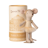 A mouse doll in a tutu and headband stands cheerfully beside a cylindrical box. The box features "Romeo & Juliet" and a theater illustration.