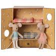 Two fabric toy mice inside a floral bunk bed box, one in a blue vest and one in a pink ballet tutu.