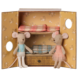Two fabric toy mice inside a floral bunk bed box, one in a blue vest and one in a pink ballet tutu.