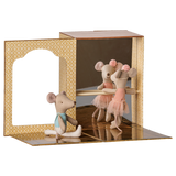 Two fabric toy mice practice ballet inside a miniature cardboard dance studio with a mirror and barre.
