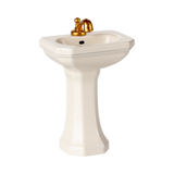 A miniature porcelain pedestal sink with a glossy finish and golden faucet. This elegant bathroom fixture conveys a sense of luxury and vintage charm.