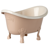 Small beige ceramic bathtub with clawfoot legs and embossed text on the side, set against a white background. The tub has a glossy finish.