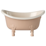 Elegant, vintage-style clawfoot miniature bathtub in pale pink with white interior, set against a white background, conveying a sense of classic charm.