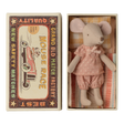 Cute toy mouse in pink polka-dot outfit lies in a small open box resembling a vintage matchbox labeled "Mouse Race," next to colorful bedding.