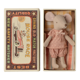 Cute toy mouse in pink polka-dot outfit lies in a small open box resembling a vintage matchbox labeled "Mouse Race," next to colorful bedding.