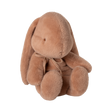 A plush, brown bunny with floppy ears and a subtle bow sits facing forward against a white background, conveying a soft and cozy feel.
