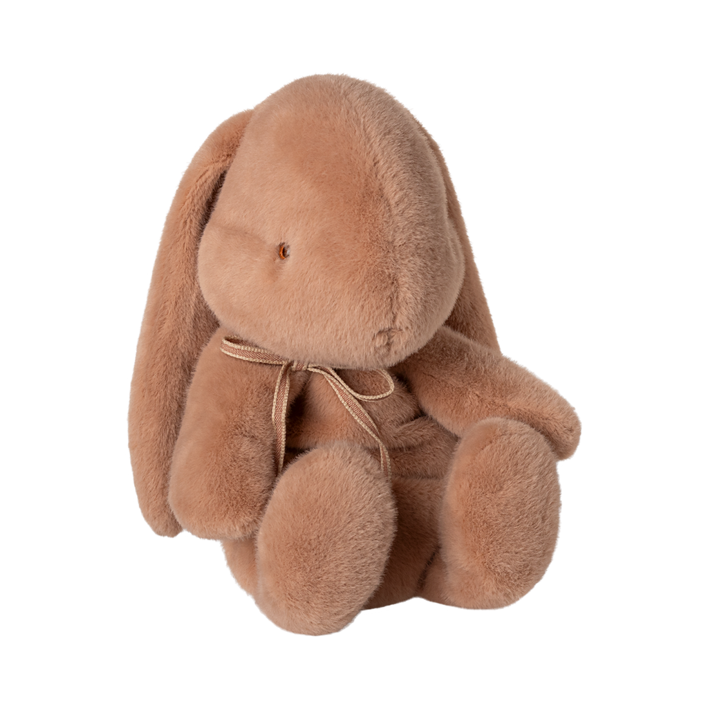 A plush, brown bunny with floppy ears and a subtle bow sits facing forward against a white background, conveying a soft and cozy feel.