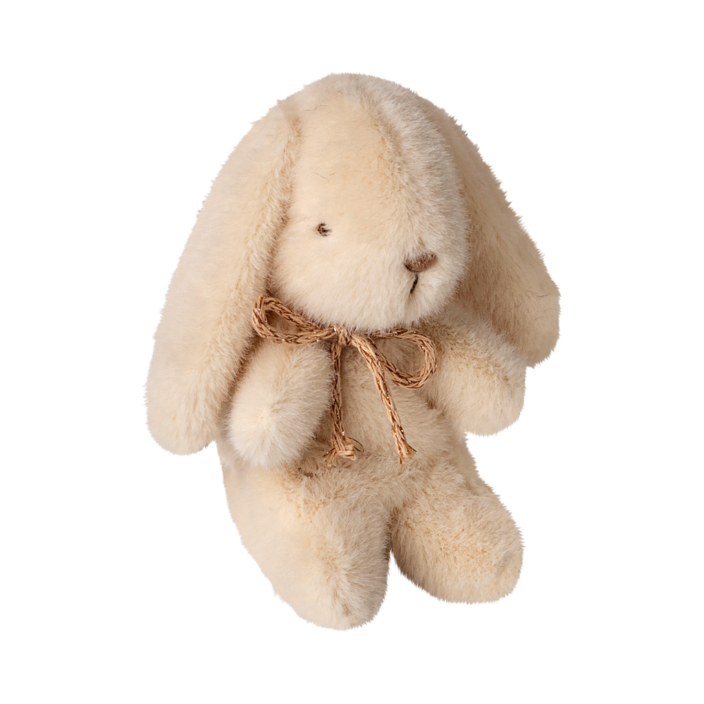 A fluffy cream-colored stuffed bunny with long ears, small black eyes, and a stitched nose, wearing a small rustic bow, sits adorably on a white background.