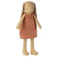 A plush rabbit toy wearing a knitted orange dress stands against a white background. It has long ears, simple stitched features, and a soft, cozy appearance.