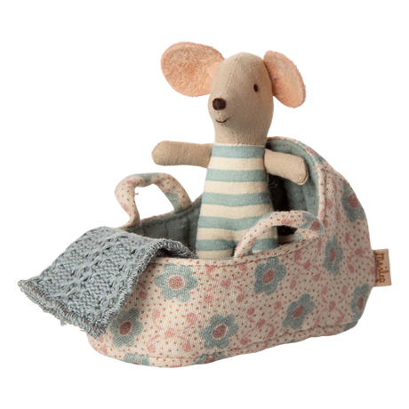 Featuring a tiny mouse in a soft blue-and-white striped onesie, resting in a floral-patterned fabric carry cot with handles and a knitted blue blanket—perfect for nurturing play and Maileg dollhouse setups.