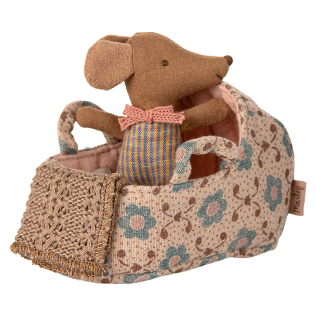 A miniature fabric carry cot with a floral rose print, complete with a soft baby mouse doll in a pink knitted outfit—ideal for imaginative play, dollhouse collections, and Maileg fans.