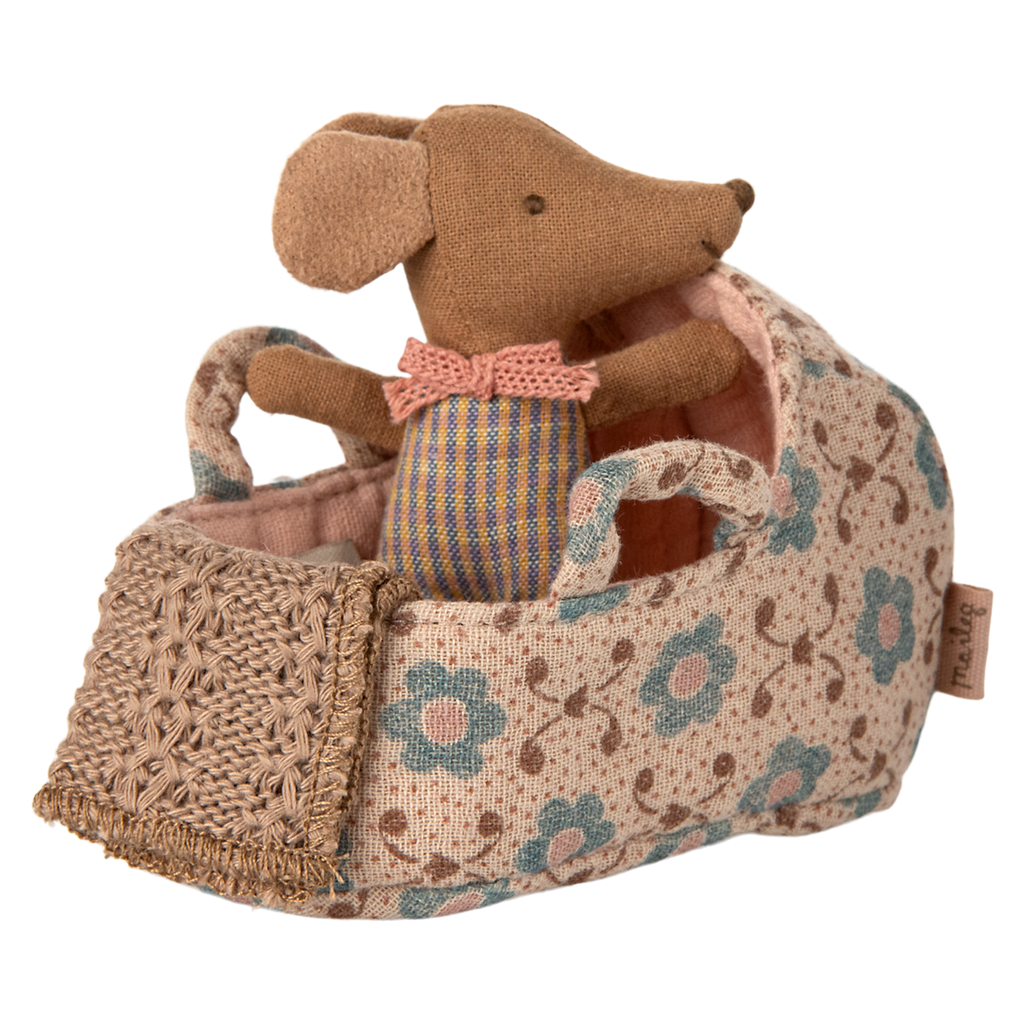 A miniature fabric carry cot with a floral rose print, complete with a soft baby mouse doll in a pink knitted outfit—ideal for imaginative play, dollhouse collections, and Maileg fans.